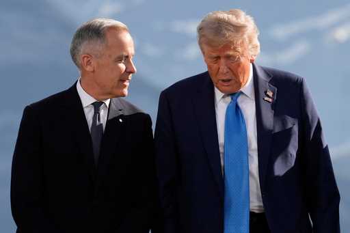 Canada's Prime Minister Mark Carney talks with President Donald Trump before a group photo at the G…