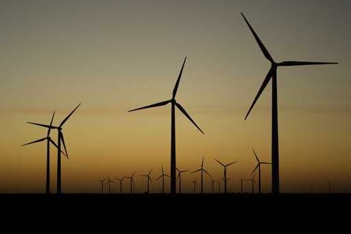 Wind turbines stretch across the horizon at dusk at the Spearville Wind Farm, Sept