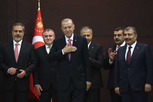 Turkish President Recep Tayyip Erdogan, center, stands with the new cabinet members during the inau…