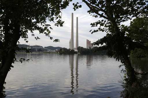 In this August 7, 2019, photo, the Kingston Fossil Plant stands near a waterway in Kingston, Tenn