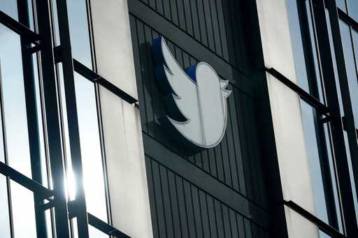 A Twitter logo hangs outside the company's offices in San Francisco, December 19, 2022