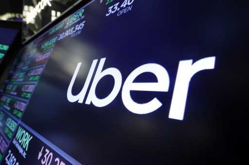 The Uber logo appears above a trading post on the floor of the New York Stock Exchange, August 16, …