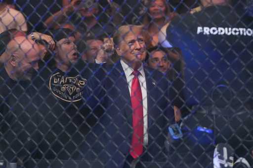 Former President Donald Trump gestures while attending the UFC 302 mixed martial arts event Saturda…