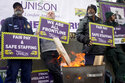 Ambulance workers stand on a picket line during a strike by members of the Unison union in the long…