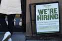 A hiring sign is displayed at a restaurant in Mount Prospect, Ill