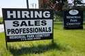 A hiring sign is displayed at a cemetery in Skokie, Ill