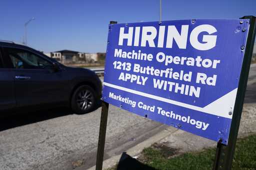 A hiring sign is posted in Downers Grove, Ill