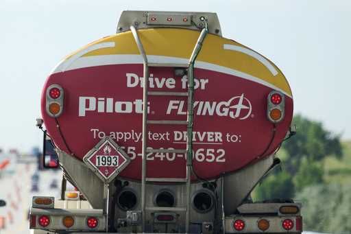A sign advertising for new drivers adorns the back of a tanker carrying fuel in the southbound lane…
