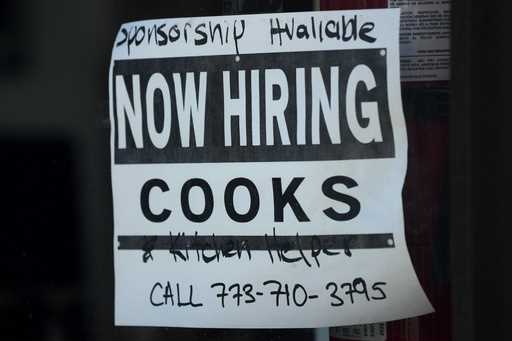 A hiring sign is displayed at a restaurant in Chicago, Monday, March 11, 2024