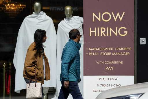 A hiring sign is displayed at a retail store in Chicago, Monday, March 11, 2024