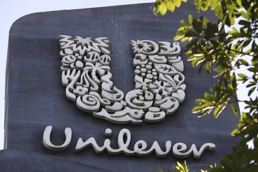 A Unilever logo is displayed outside the head office of PT Unilever Indonesia Tbk