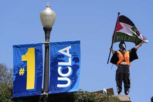 Demonstrators wave flags on the UCLA campus, after nighttime clashes between Pro-Israel and Pro-Pal…