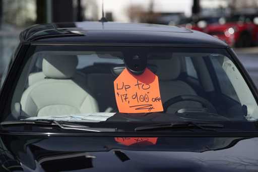 A sign noting a discount is displayed in an unsold 2024 Cooper SE electric hardtop at a Mini dealer…