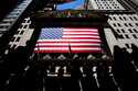 People walk past the New York Stock Exchange on Wednesday, June 29, 2022 in New York