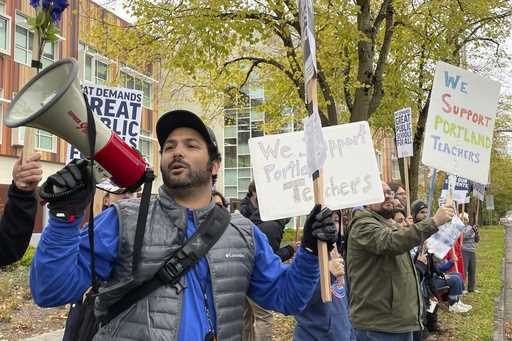 Teachers and their supporters hold signs, chant and rally the crowd with bullhorns on the first day…