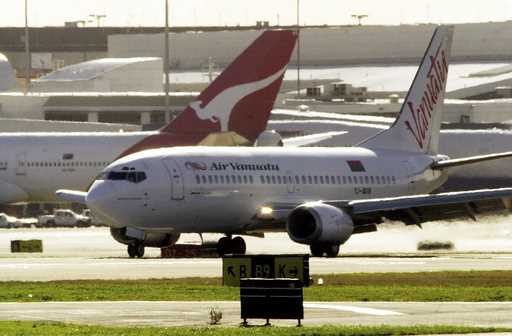 An Air Vanuatu plane makes an emergency landing at Sydney Airport, August 2, 2001, after suspected …
