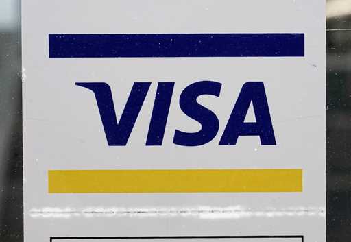 A Visa sign is displayed on the front door of a local business, April 27, 2021, in Urbandale, Iowa