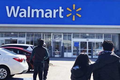 Shoppers walk to a Walmart in Vernon Hills, Ill