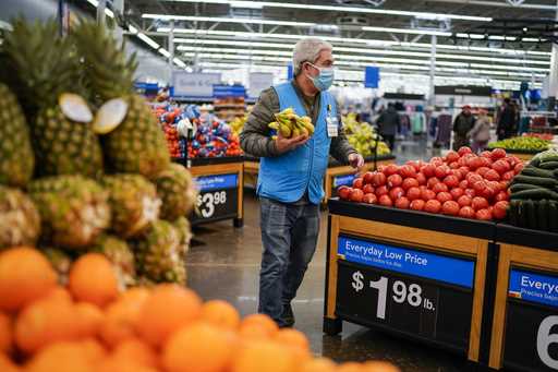 A worker carries bananas inside the Walmart Supercenter on February 9, 2023, in North Bergen, New J…
