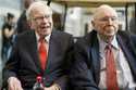 FILE- In this May 3, 2019 file photo, Berkshire Hathaway Chairman and CEO Warren Buffett, left, and…