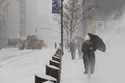 Pedestrians walk down Fifth Avenue during a winter storm, Sunday, January 25, 2026, in New York