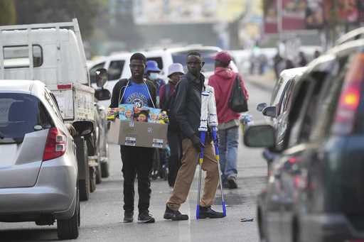 Street traders sell various goods to motorists on the streets of Harare, in this May, 10, 2023 phot…