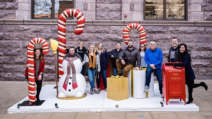 MarketBeat staff interacting with features of the holiday Plaza