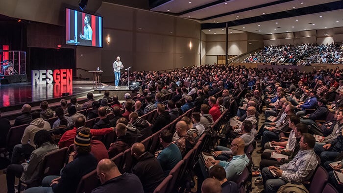 Crowd  listen to keynote speaker at Restoration Generation Men's Summit