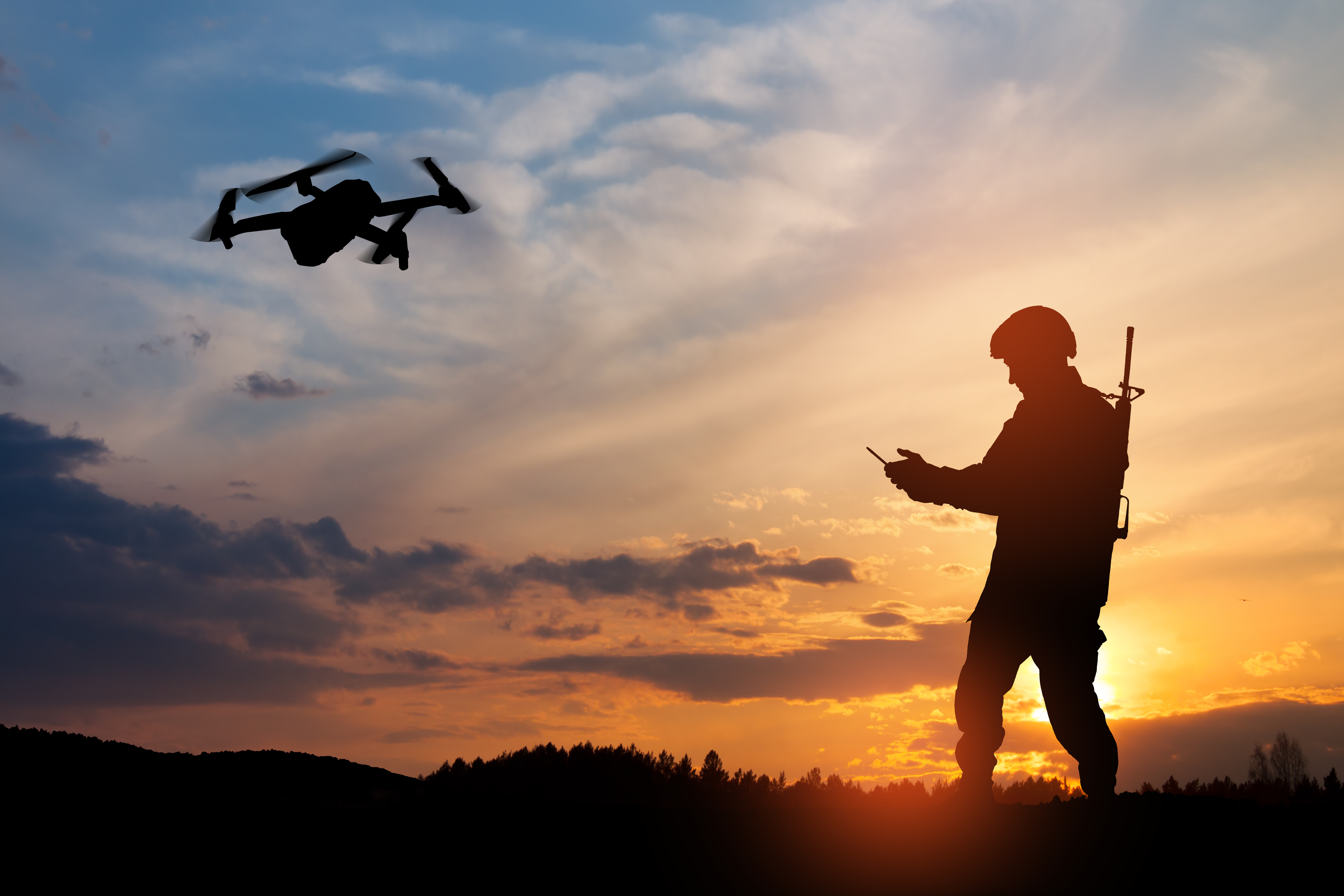 Silhouette of soldier using drone