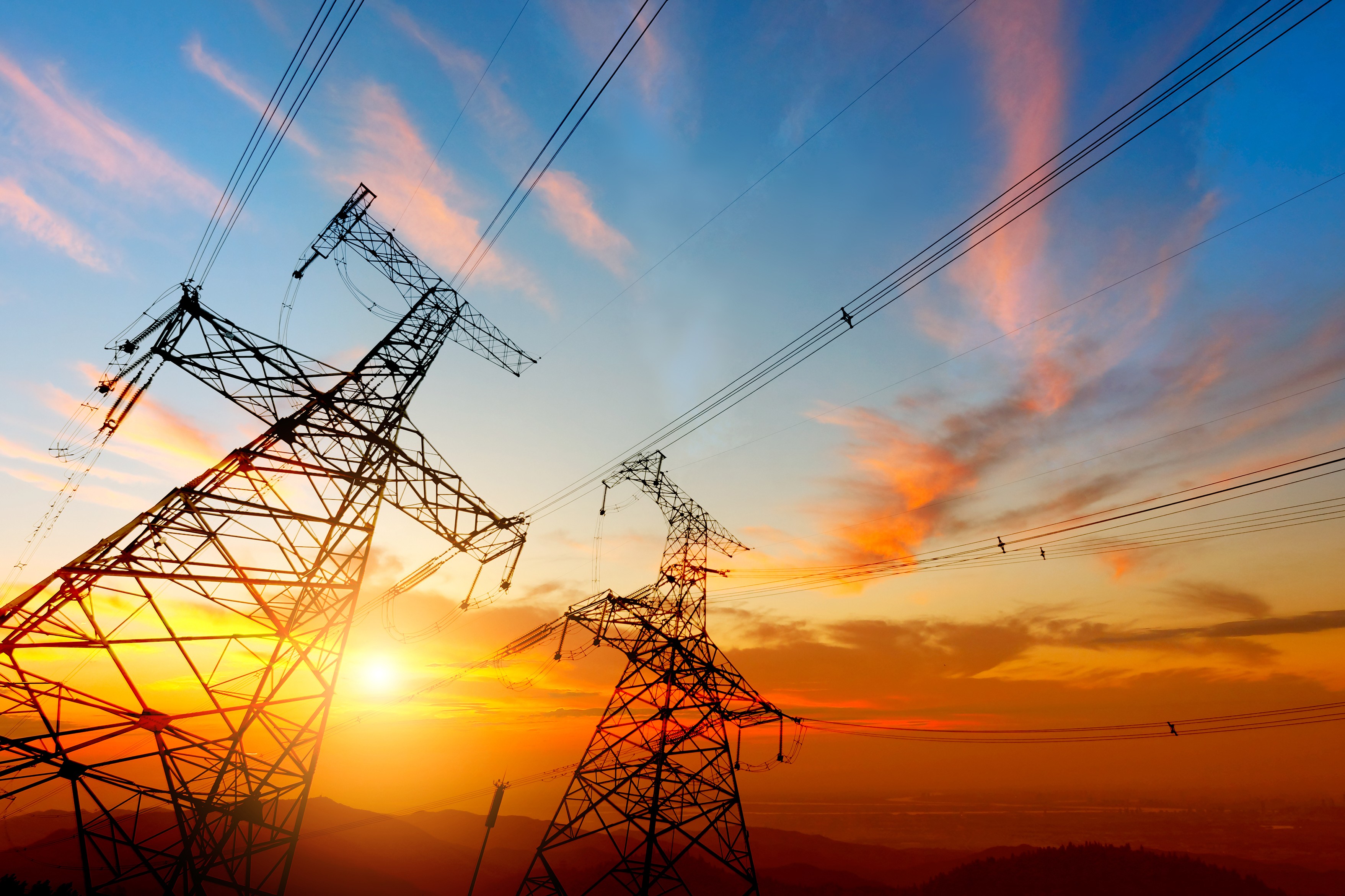 image of electric transmission lines at sunset