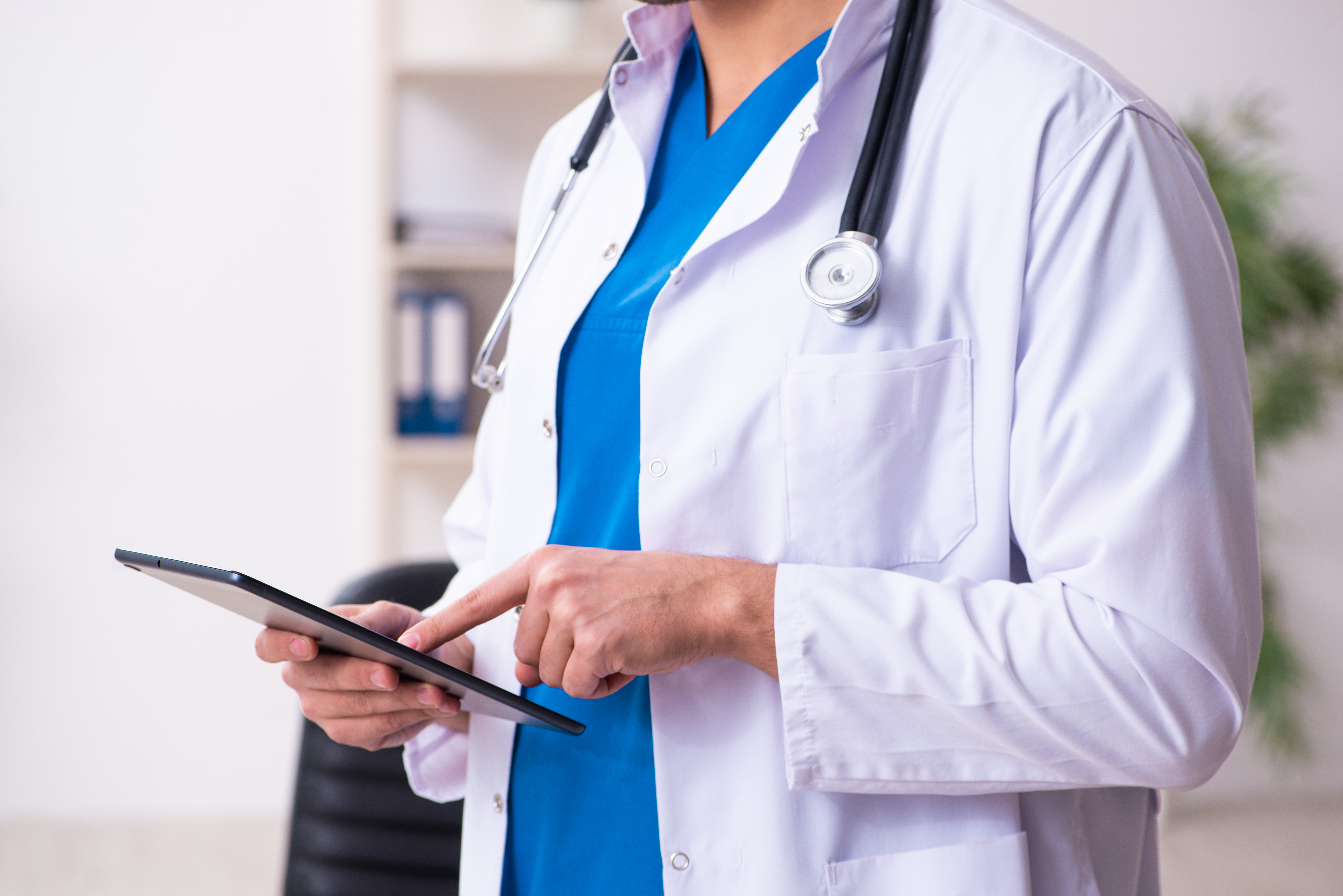 photo of doctor holding tablet suggesting telehealth visit