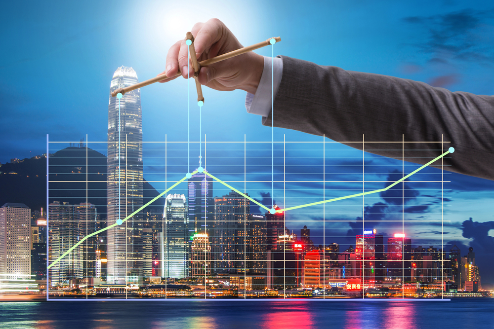 Businessman controlling the market with strings