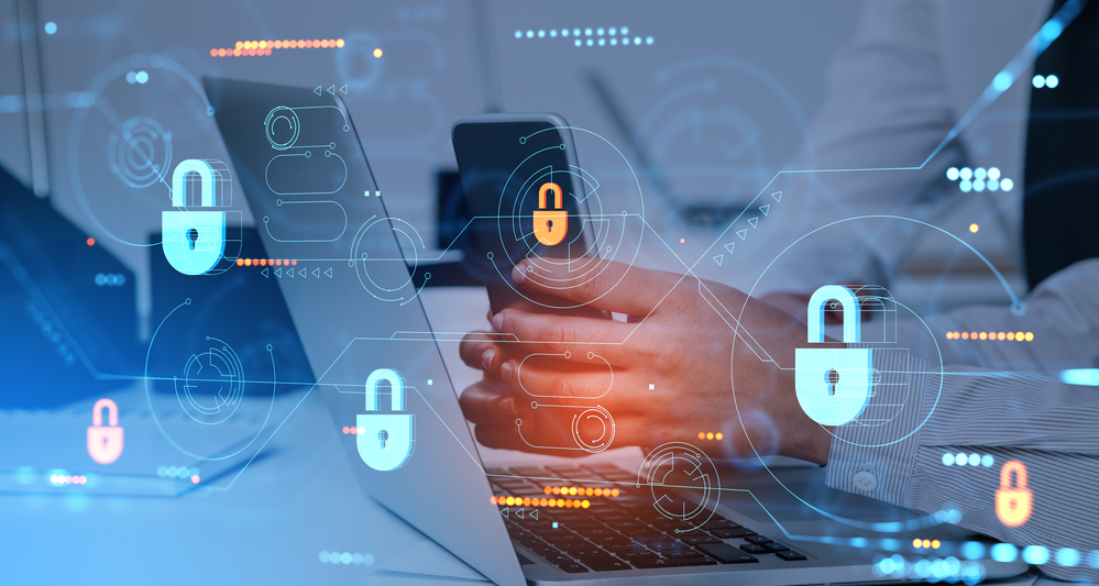 Hands of businesswoman using smartphone and laptop in blurry office with double exposure of immersive data protection interface