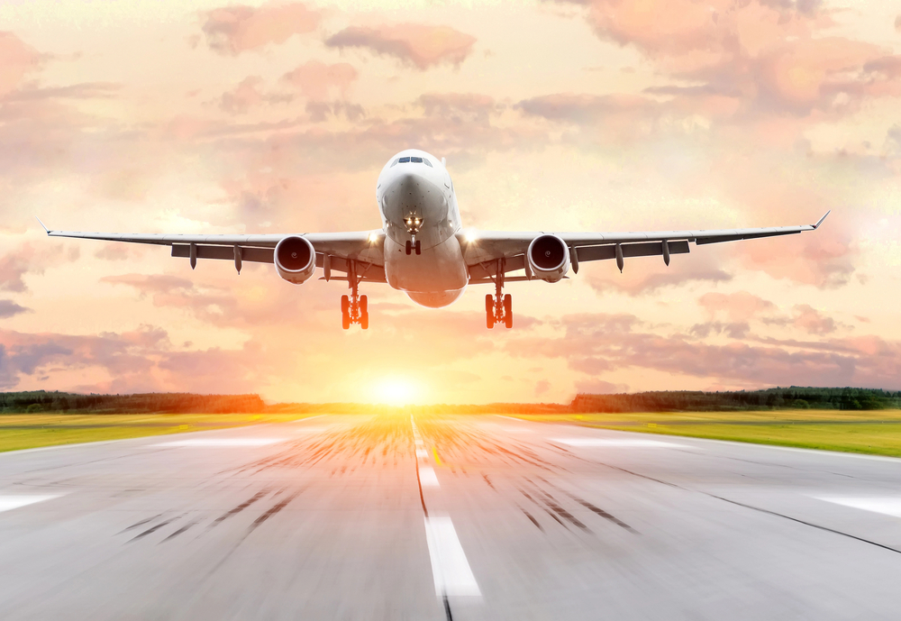 Airplane landing with sunset