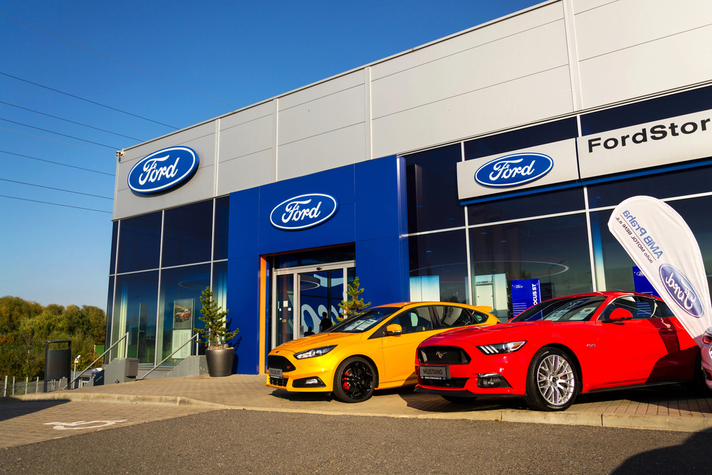 Cars in front of Ford motor company dealership building