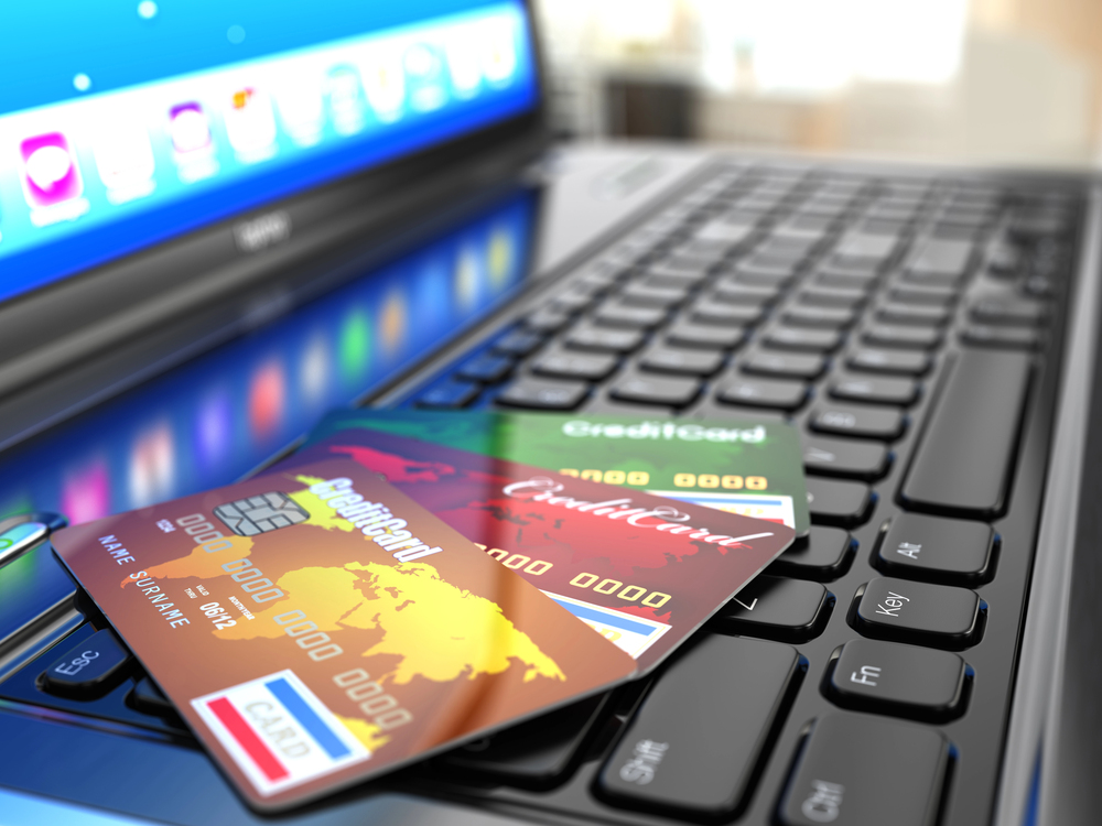 Online purchase. Credit card on laptop keyboard