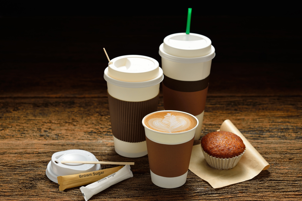 cups of coffee and muffin on black background