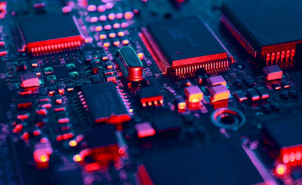 Computer Microchips  on Electronic circuit board. Technology microelectronics concept background. Macro shot, selective focus, extremely shallow DOF. Noises and large grain - stylization under film.