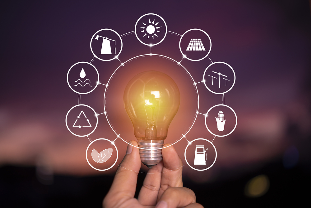 Ecology concept. Power energy in nature. hand holding lightbulb with solar with icons energy sources for renewable, sustainable development.