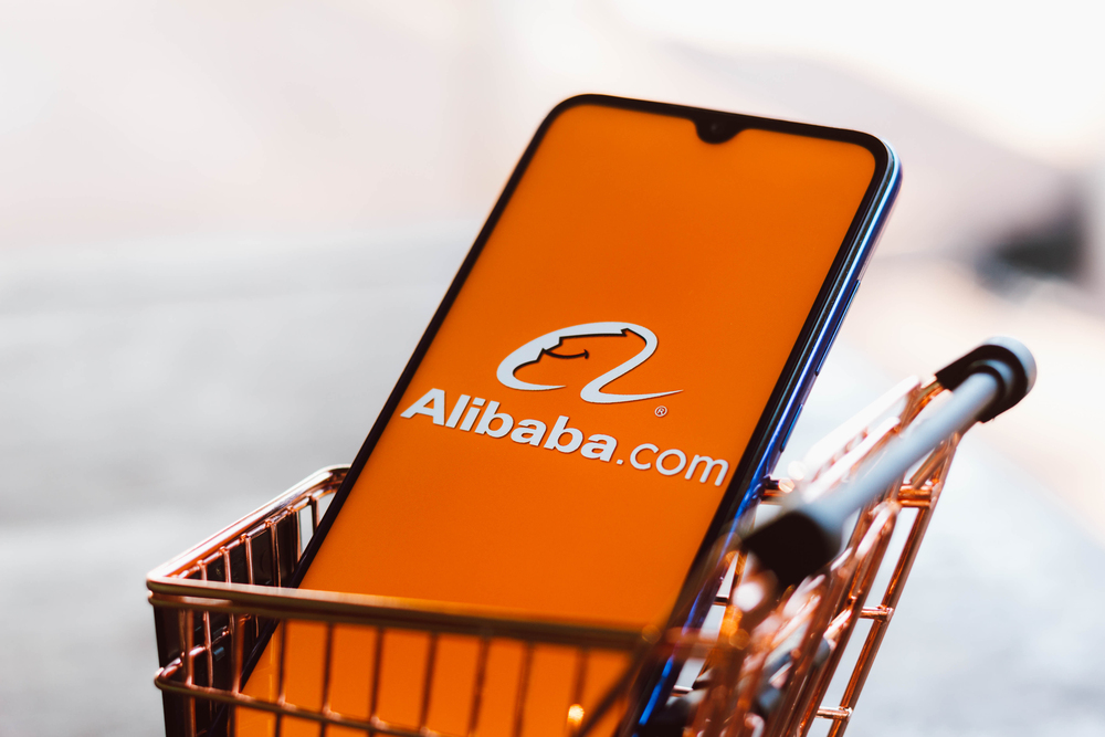 Brazil. In this photo illustration the Alibaba.com logo displayed on a smartphone along with a shopping cart