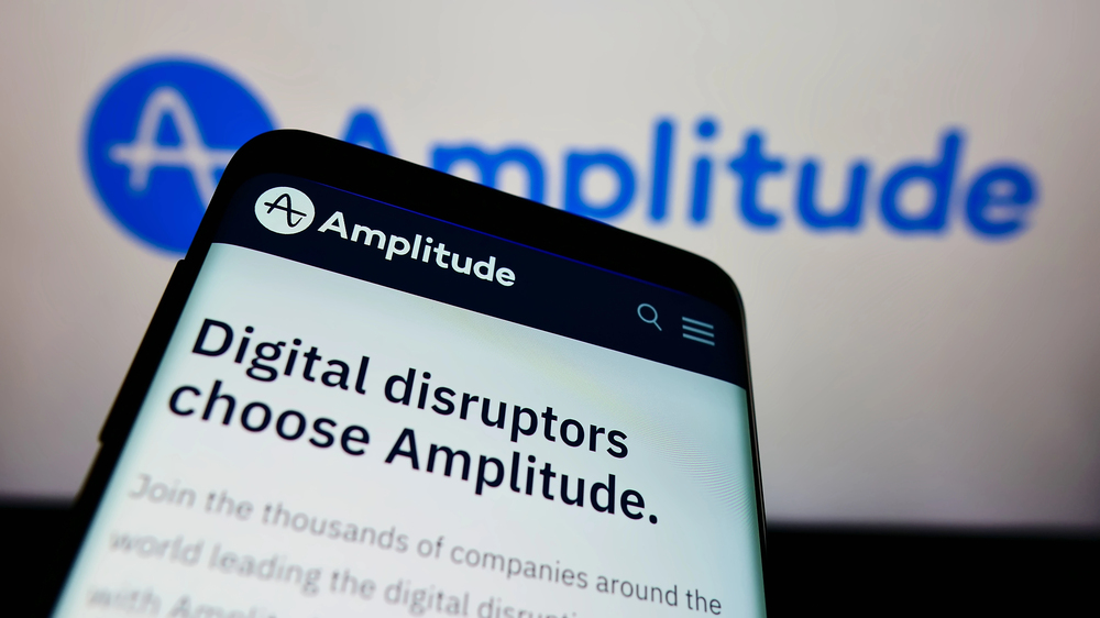 STUTTGART, GERMANY - Dec 13, 2021: Mobile phone with webpage of US analytics software company Amplitude Inc. on screen in front of logo. Focus on top-left of phone display. - Stock Editorial Photography