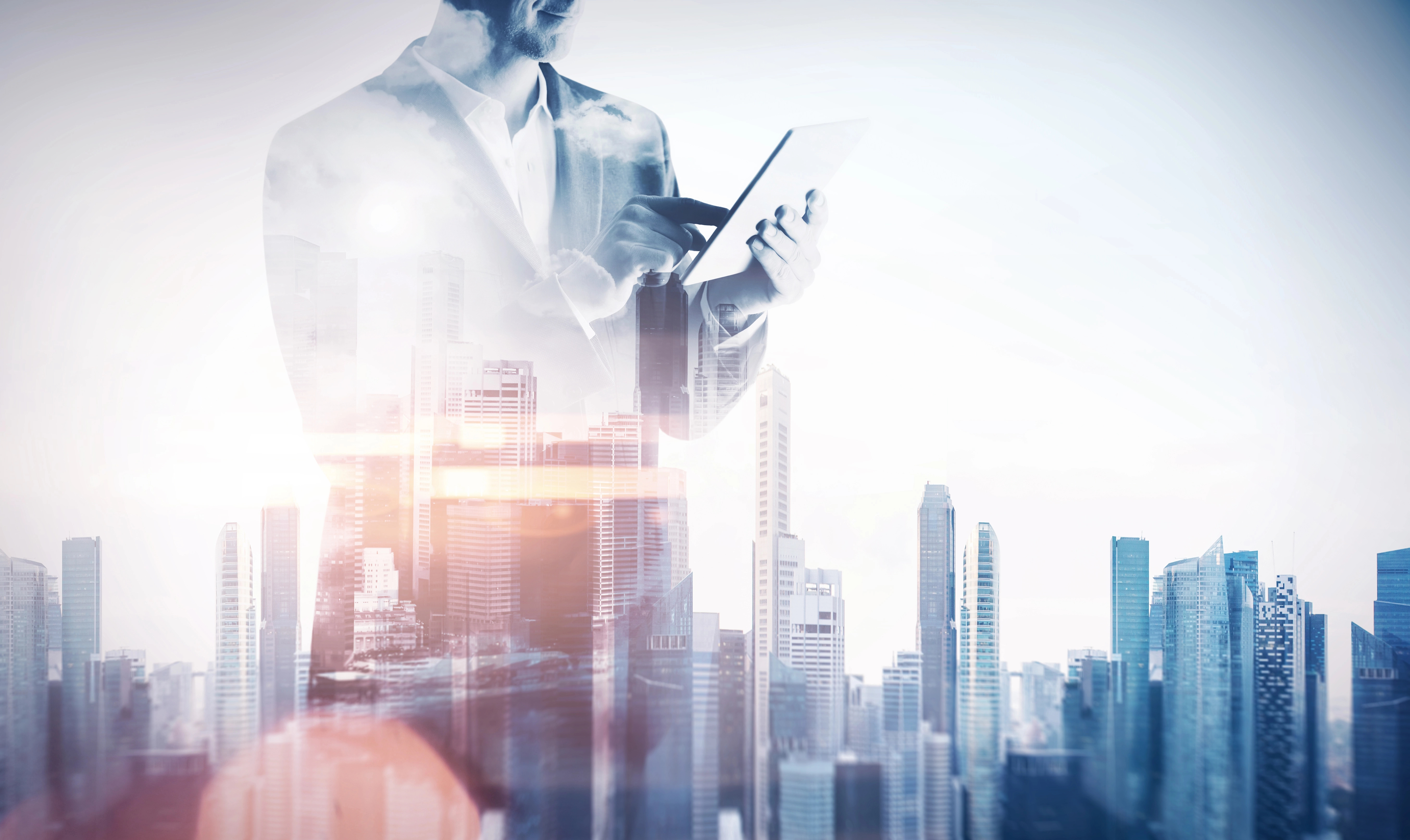 Entrepreneur on laptop over a city scape