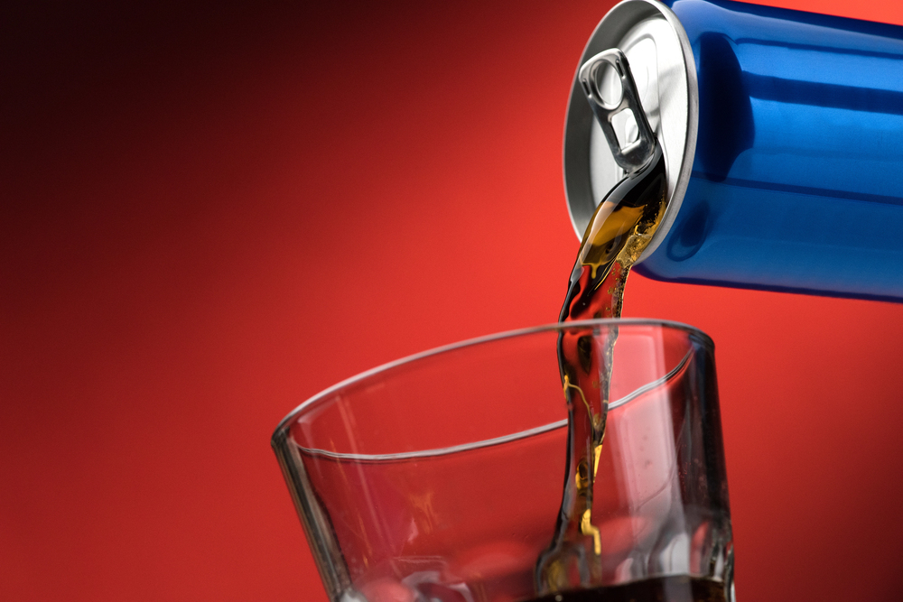 Pouring soft drink in glass - stock image