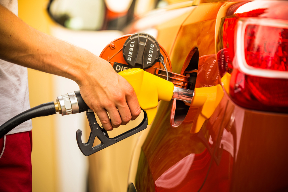 Gasoline dispenser in the car. — Photo