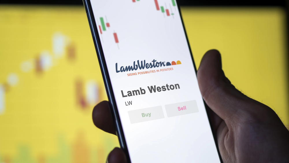 The logo of Lamb Weston on the screen of an exchange. Lamb Weston price stocks, $LW on a device. - Stock Editorial Photography