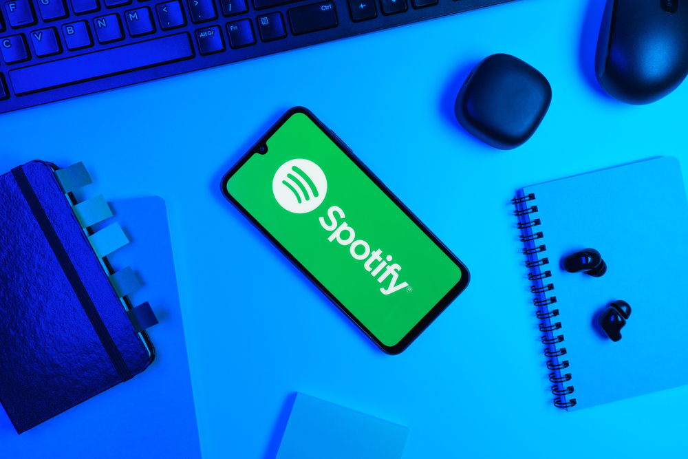 Prague, Czechia - 10 21 2024: Smartphone on surface showing Spotify logo. — Stock Editorial Photography