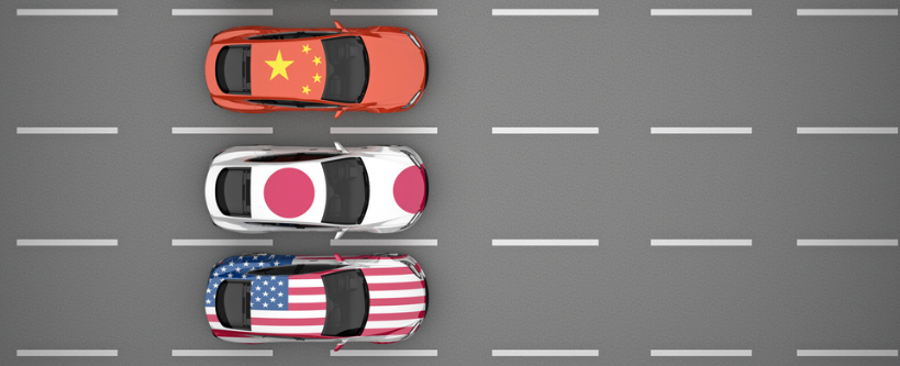 Photo of a group of cars painted in the flag of the country on a roadway, separated by white lines