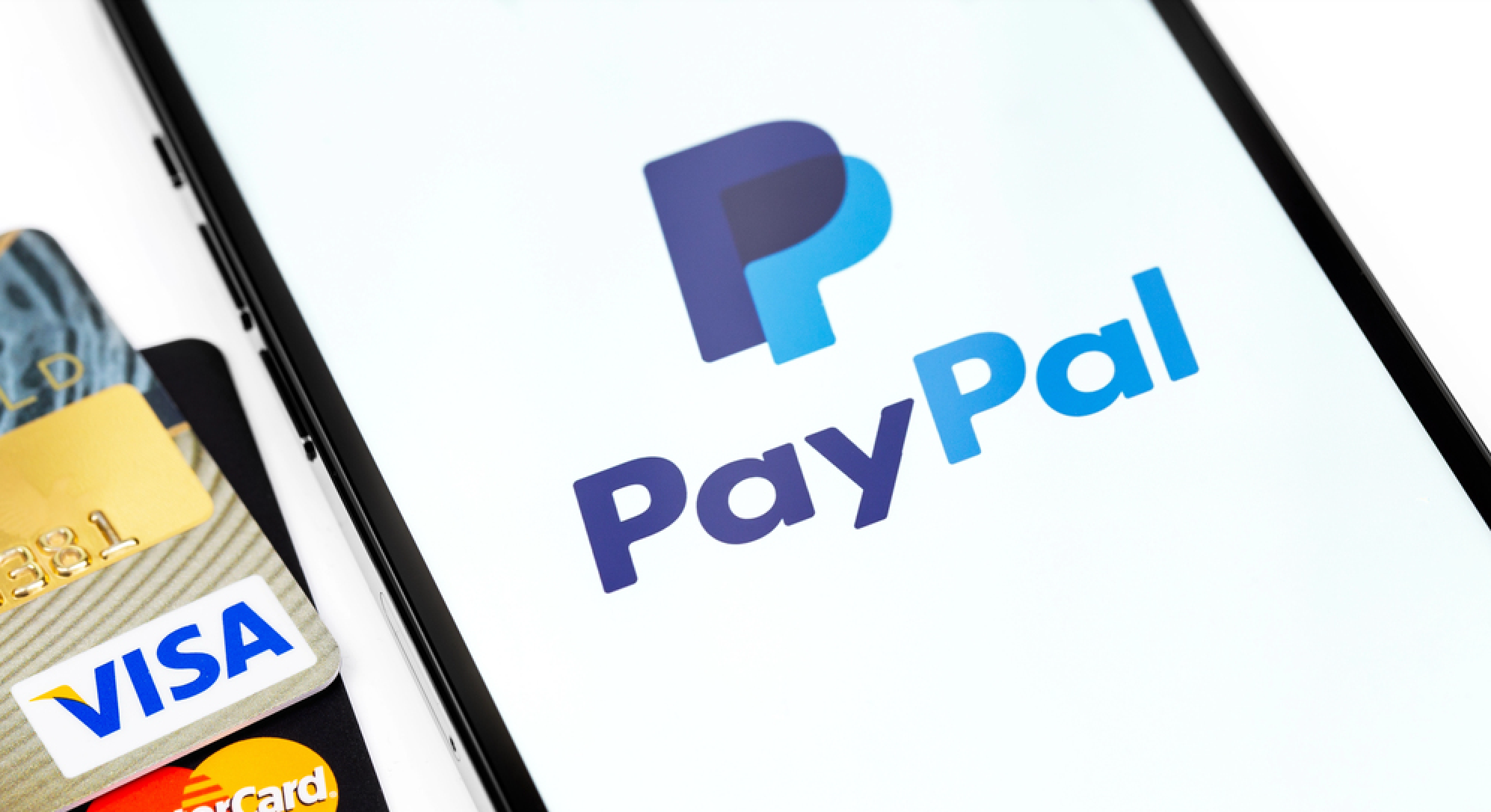 Visa, MasterCard plastic electronic cards and smartphone with PayPal logo on screen. Visa and MasterCard worldwide is an American multinational financial services corporation. Moscow, Russia - April 16, 2021 — Stock Editorial Photography