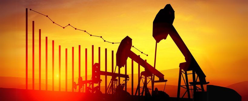 Photo of oil rigs at sunset on top of a declining stock market chart.