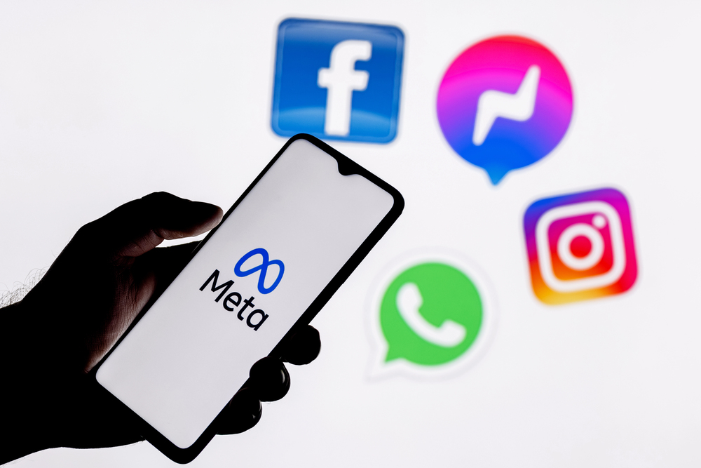 Kazan, Russia - Oct 28, 2021: Facebook changes its name to Meta. Smartphone with Meta logo on the background on logos of products owned by facebook metaverse. - Stock Editorial Photography
